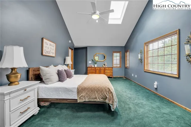 a bed room with a bed and a television