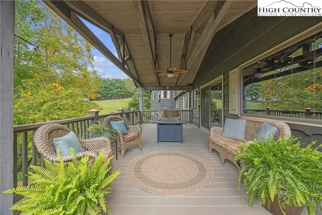 a living room with furniture a flat screen tv and wooden floor