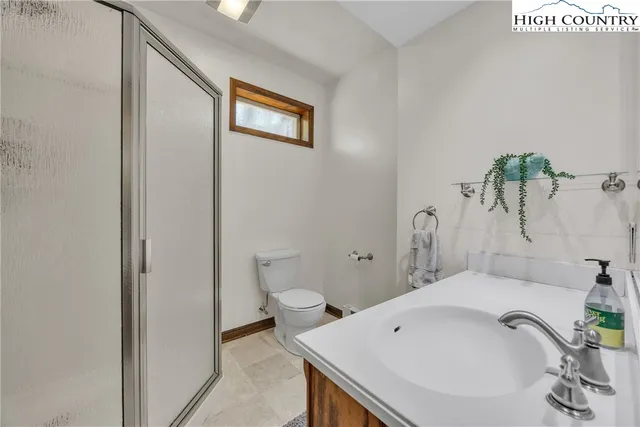 a bedroom with a bed table and a window