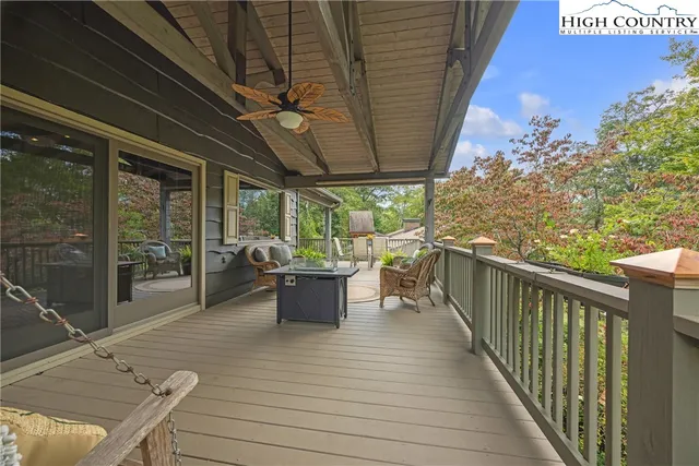 a view of a balcony with wooden floor and iron fence