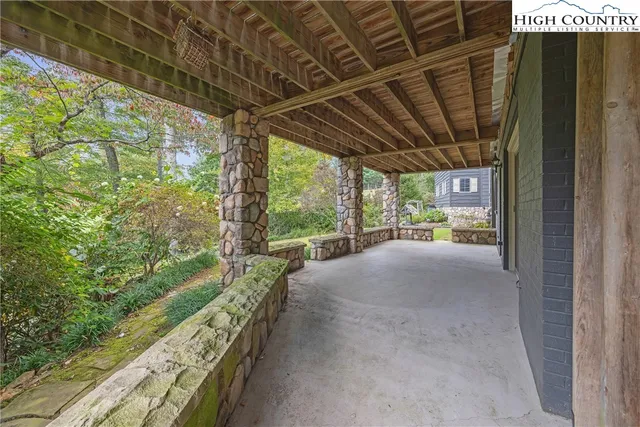 a view of a house with brick walls and a yard