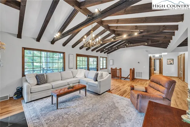 a living room with furniture and a chandelier