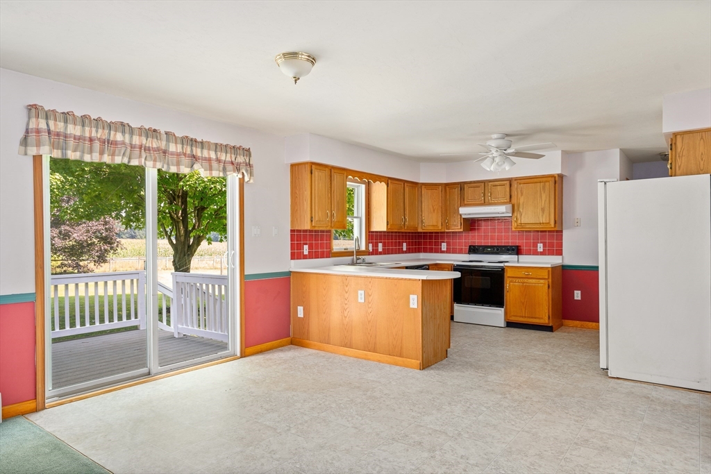36 Depot Road Hatfield, MA 01038 - Photo 17 of 39 a kitchen with kitchen island a large window and a refrigerator