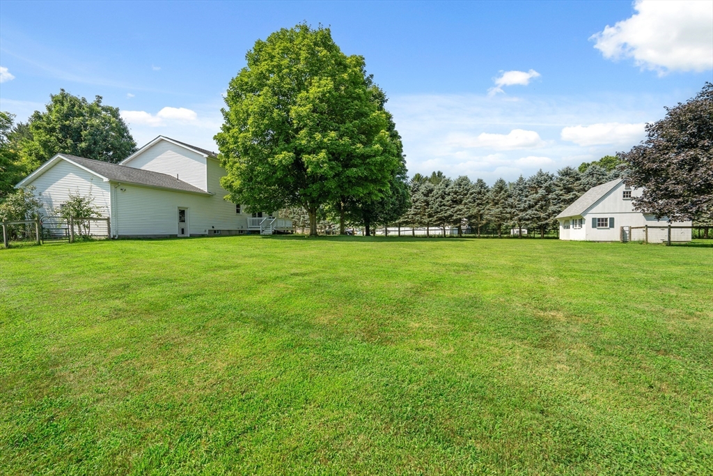 36 Depot Road Hatfield, MA 01038 - Photo 4 of 39 a view of a house with a yard and garage