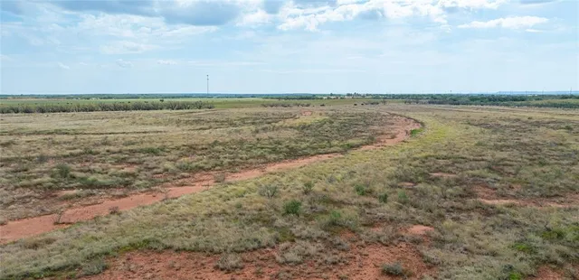 a view of a field with an ocean beach