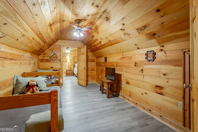 a room with wooden floors and pool table