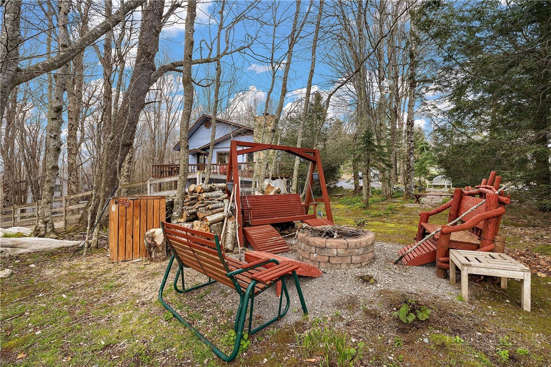 103-105 Upper Grouse Ridge Road Beech Mountain, NC 28604 - Photo 48 of 48 a backyard of a house with table and chairs