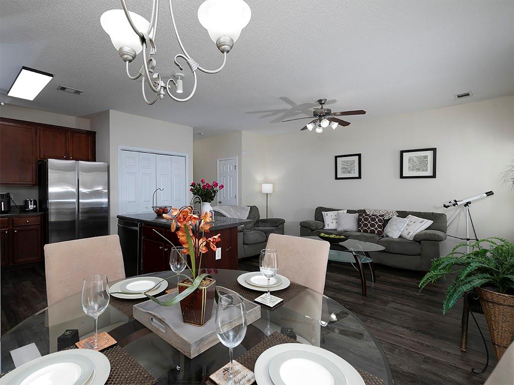 7699 Bucknell Terrace Fairburn, GA 30213 - Photo 15 of 34 a living room with furniture chandelier and kitchen view