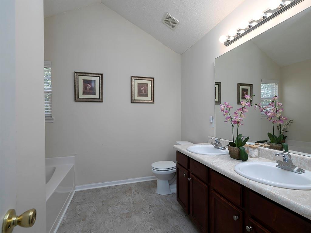 7699 Bucknell Terrace Fairburn, GA 30213 - Photo 20 of 34 a bathroom with a double vanity sink mirror and toilet