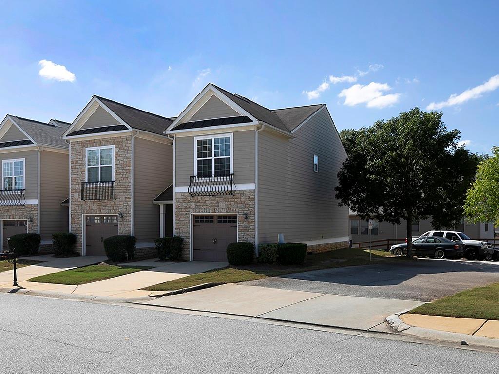 7699 Bucknell Terrace Fairburn, GA 30213 - Photo 2 of 34 a front view of a house with a yard