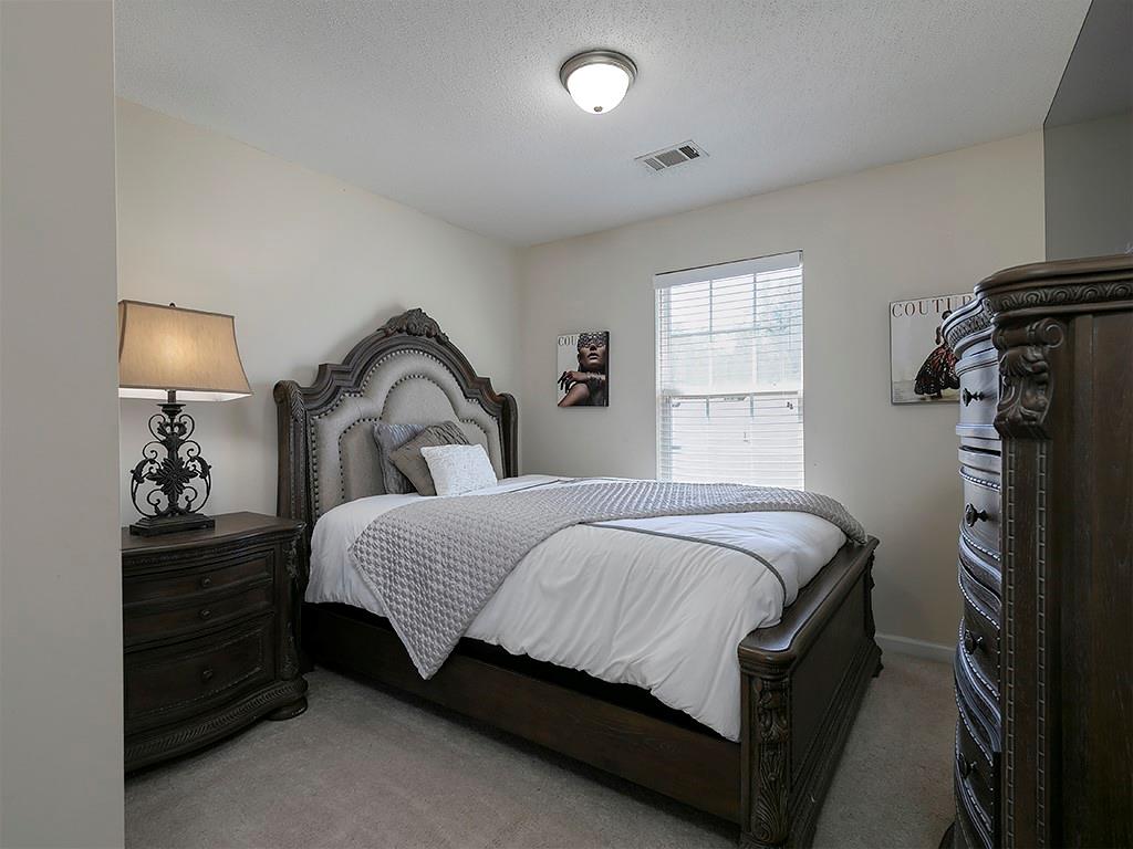 7699 Bucknell Terrace Fairburn, GA 30213 - Photo 22 of 34 a bedroom with a bed and a window
