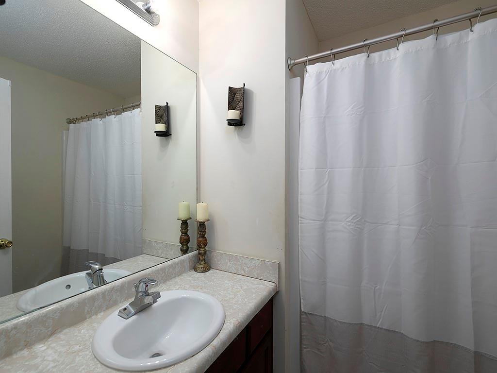 7699 Bucknell Terrace Fairburn, GA 30213 - Photo 24 of 34 a bathroom with a sink and a mirror
