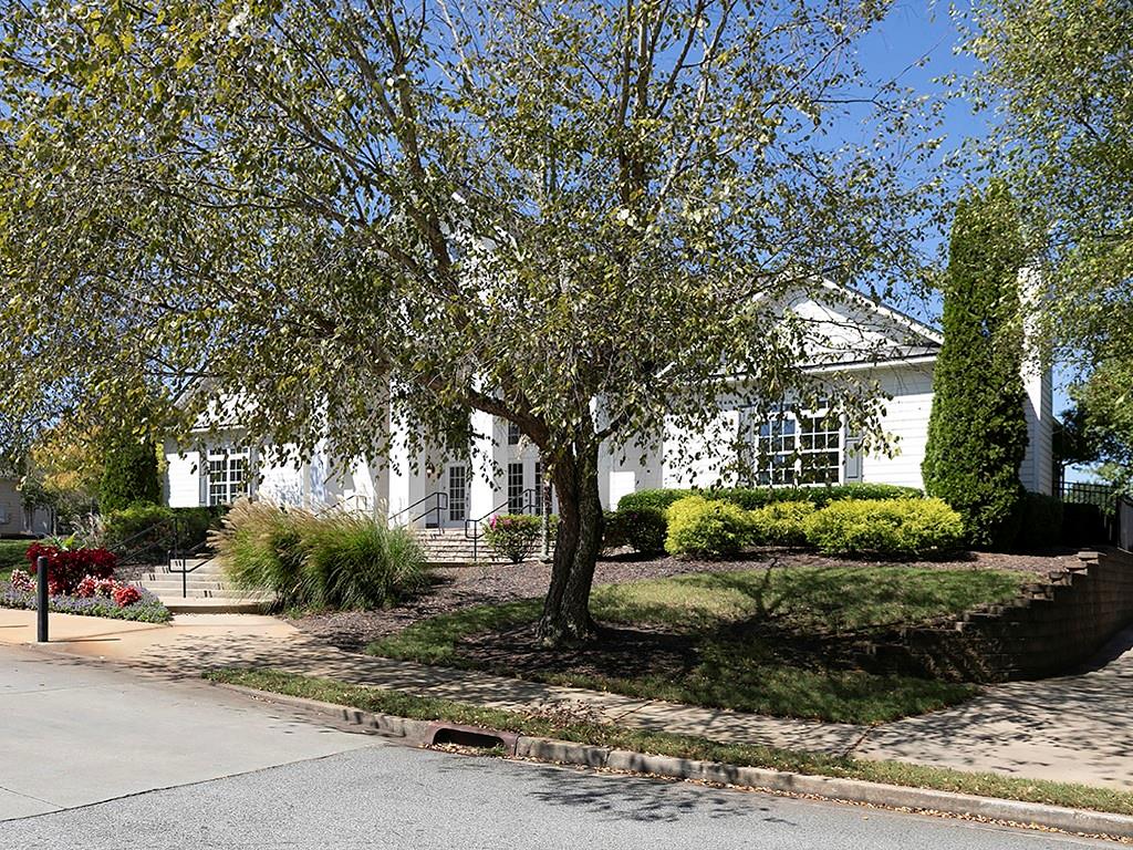 7699 Bucknell Terrace Fairburn, GA 30213 - Photo 29 of 34 a front view of a house with a yard and potted plants