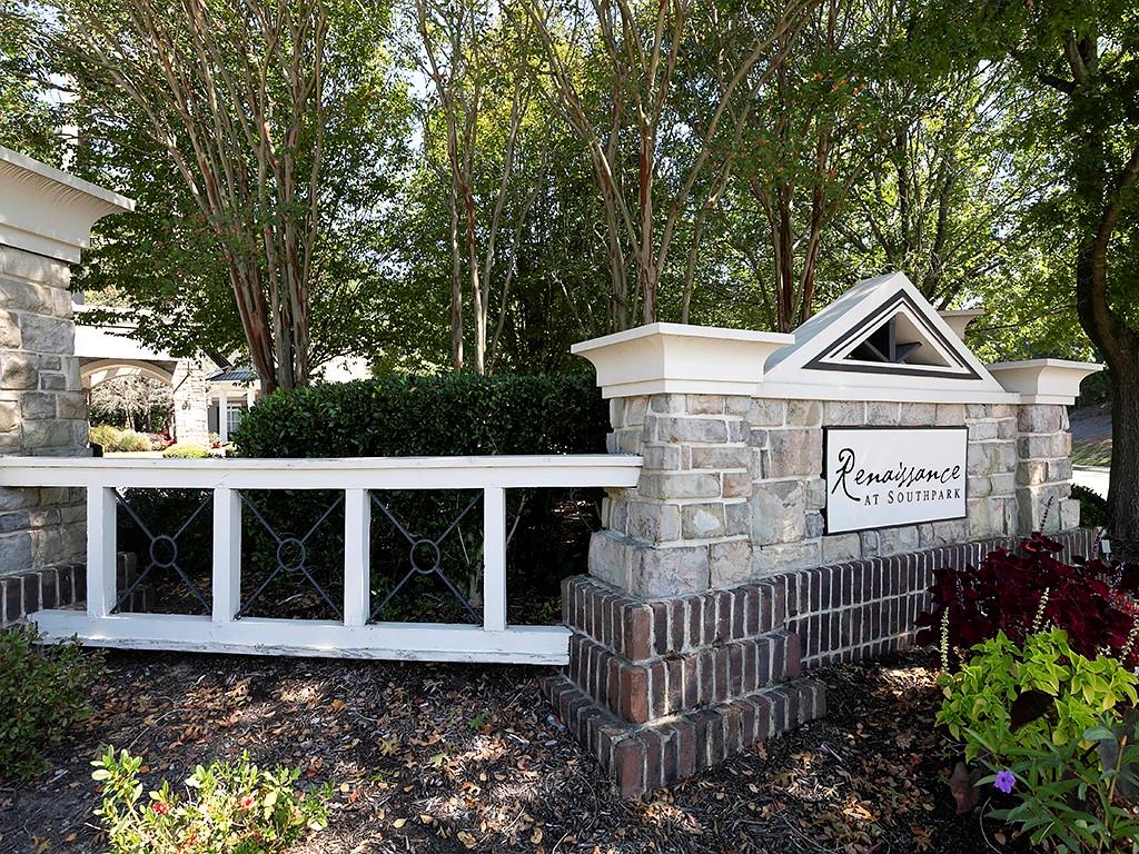 7699 Bucknell Terrace Fairburn, GA 30213 - Photo 34 of 34 a view of a brick house with a small yard and a large tree