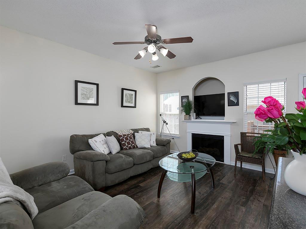 7699 Bucknell Terrace Fairburn, GA 30213 - Photo 8 of 34 a living room with furniture fireplace and flat screen tv