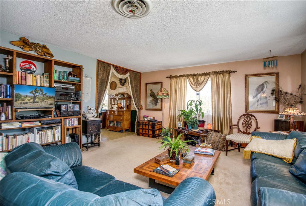 5407 Paradise View Road Yucca Valley, CA 92284 - Photo 11 of 63 a living room with furniture and a large window