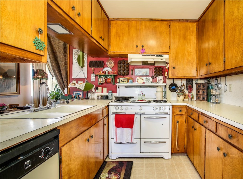 5407 Paradise View Road Yucca Valley, CA 92284 - Photo 17 of 63 a kitchen with a sink a stove and cabinets