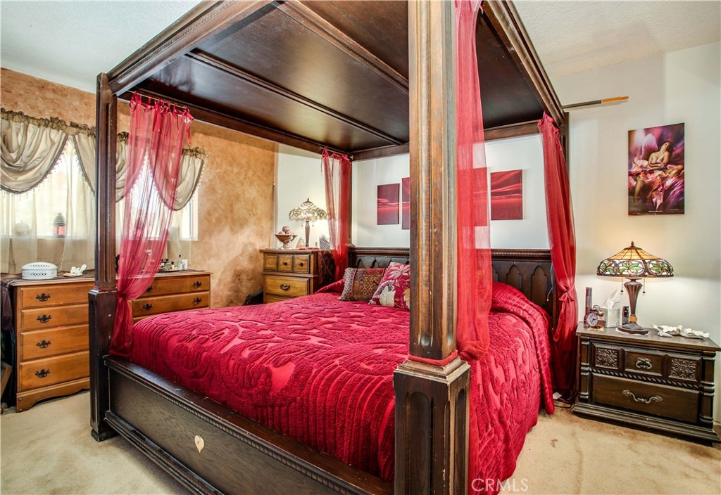 5407 Paradise View Road Yucca Valley, CA 92284 - Photo 22 of 63 a bedroom with a bed and wooden floor