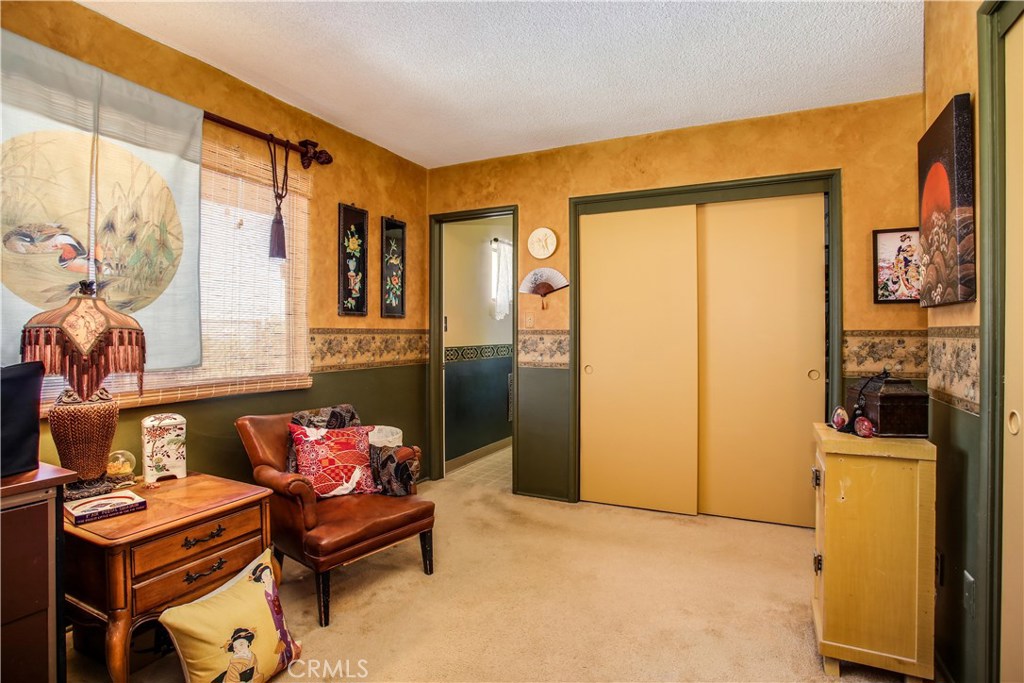 5407 Paradise View Road Yucca Valley, CA 92284 - Photo 25 of 63 a bedroom with furniture and a window