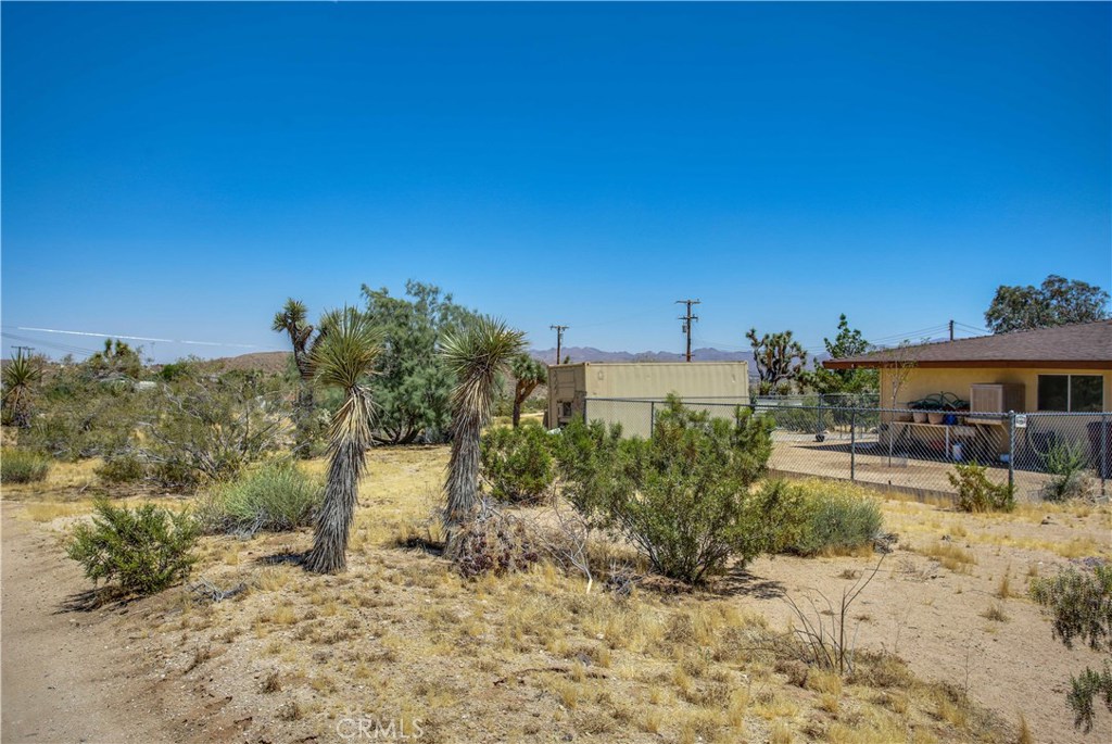 5407 Paradise View Road Yucca Valley, CA 92284 - Photo 31 of 63 a view of a yard with table and chairs