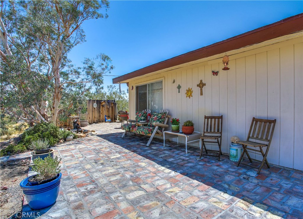 5407 Paradise View Road Yucca Valley, CA 92284 - Photo 53 of 63 a view of a backyard with chairs and plants