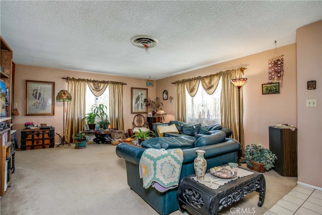 5407 Paradise View Road Yucca Valley, CA 92284 - Photo 10 of 63 a living room with furniture and a large window