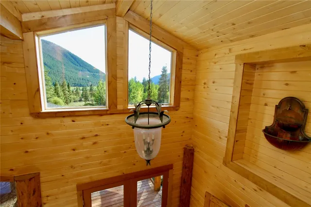 a view of a balcony with chair and wooden floor