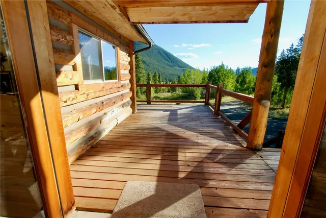 a view of a balcony with wooden floor and iron fence