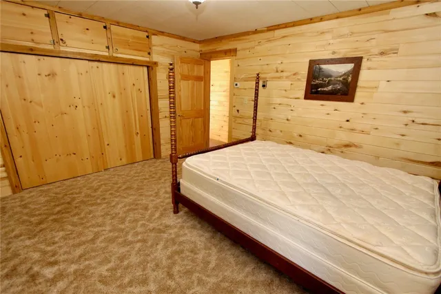 a bedroom with a bed and a wall painting