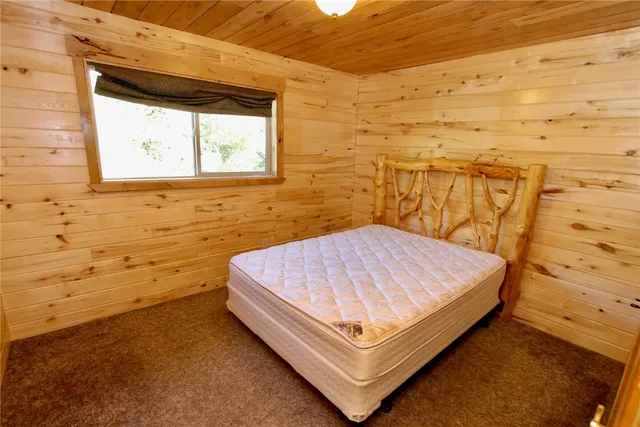 a bed sitting in a bathroom next to a blue wall