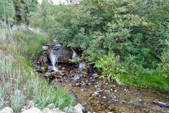 a view of a patio with table and chairs and potted plants