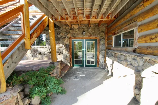 a view of a porch with furniture and a yard