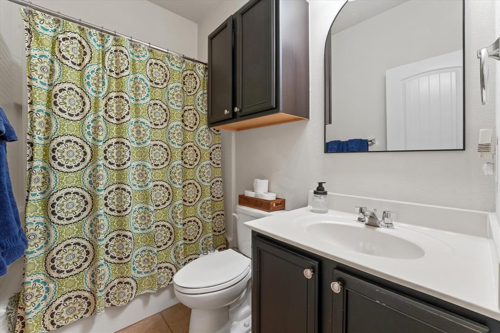 3801 Surf Street Denton, TX 76208 - Photo 22 of 29 Bathroom with vanity, shower / bathtub combination with curtain, and light tile patterned flooring