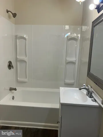 a bathroom with a sink a mirror and a bathtub