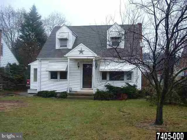 a front view of a house with a garden and yard