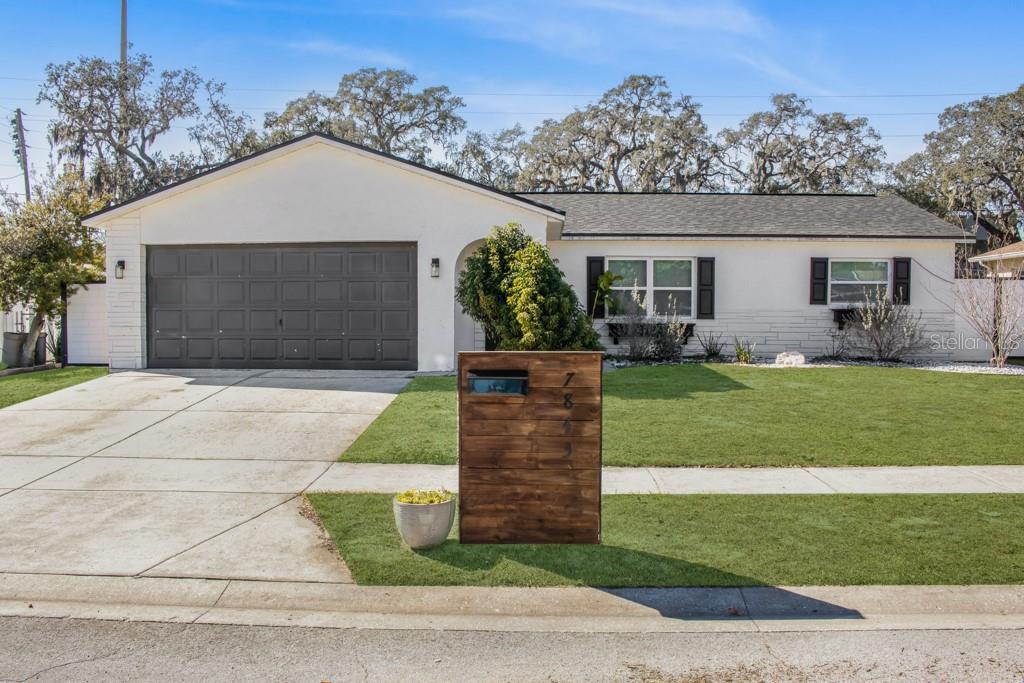 7843 Crosier Court New Port Richey, FL 34653 - Photo 1 of 1 a front view of a house with a yard and garage