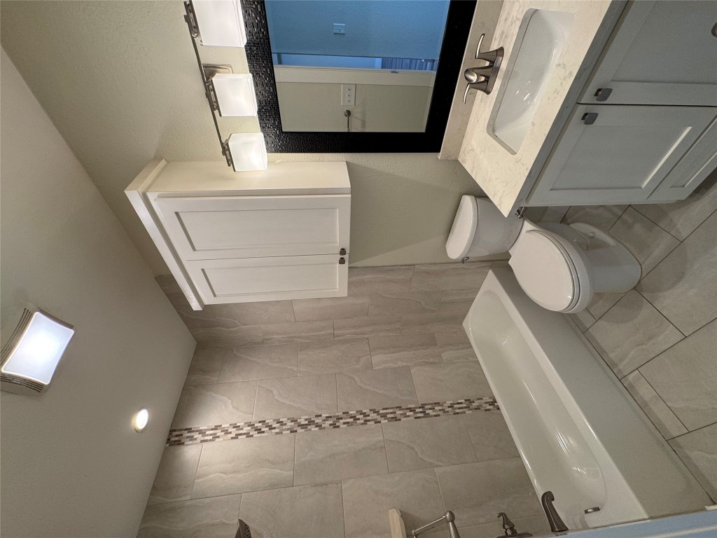 2417 West Slaughter Lane, Unit D Austin, TX 78748 - Photo 13 of 13 a bathroom with a sink a toilet and shower