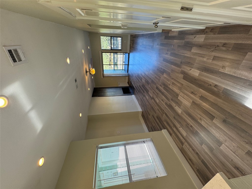 2417 West Slaughter Lane, Unit D Austin, TX 78748 - Photo 2 of 13 an empty room with wooden floor and windows