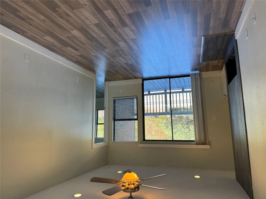 2417 West Slaughter Lane, Unit D Austin, TX 78748 - Photo 3 of 13 wooden floor in an empty room with a window
