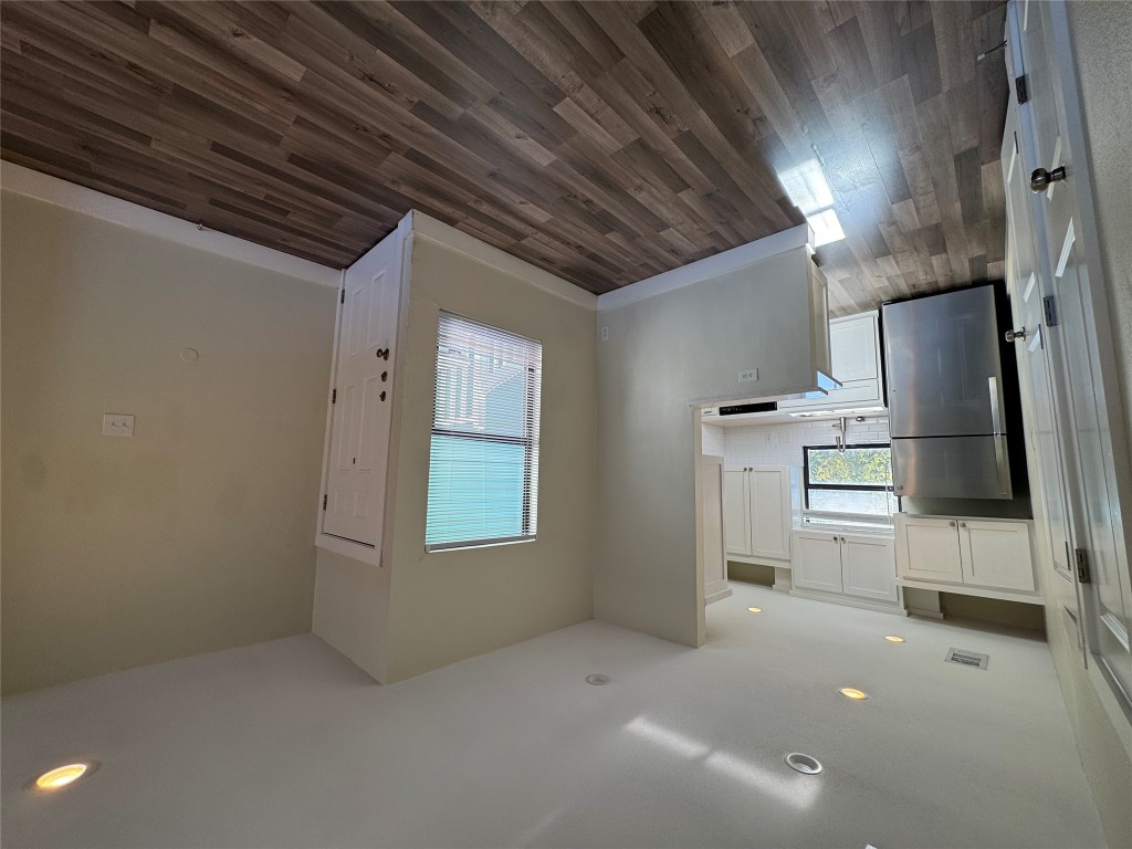 2417 West Slaughter Lane, Unit D Austin, TX 78748 - Photo 5 of 13 a view of empty room with wooden floor and electronic appliances