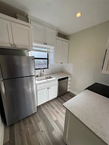 a kitchen with a sink stainless steel appliances and cabinets