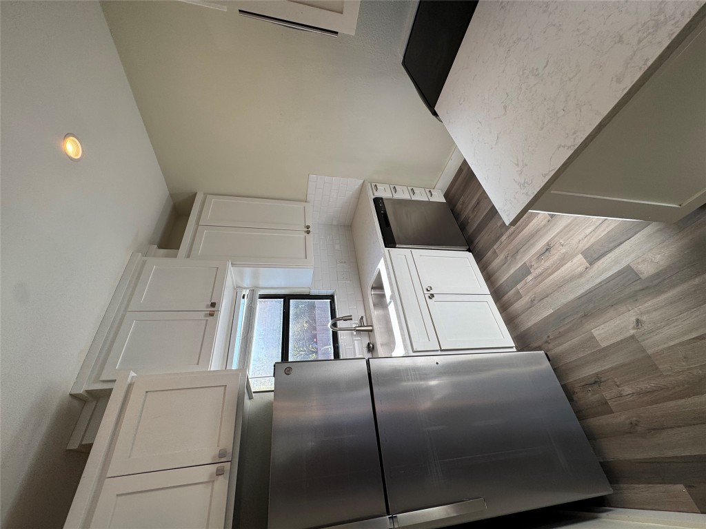 2417 West Slaughter Lane, Unit D Austin, TX 78748 - Photo 6 of 13 a kitchen with a sink stainless steel appliances and cabinets