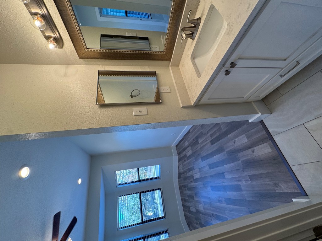 2417 West Slaughter Lane, Unit D Austin, TX 78748 - Photo 8 of 13 a bathroom with a granite countertop sink and mirror