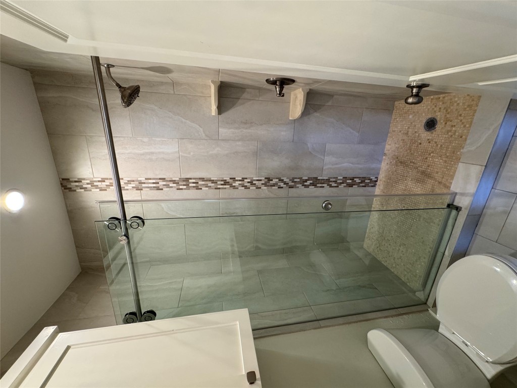 2417 West Slaughter Lane, Unit D Austin, TX 78748 - Photo 9 of 13 a bathroom with a shower and a toilet