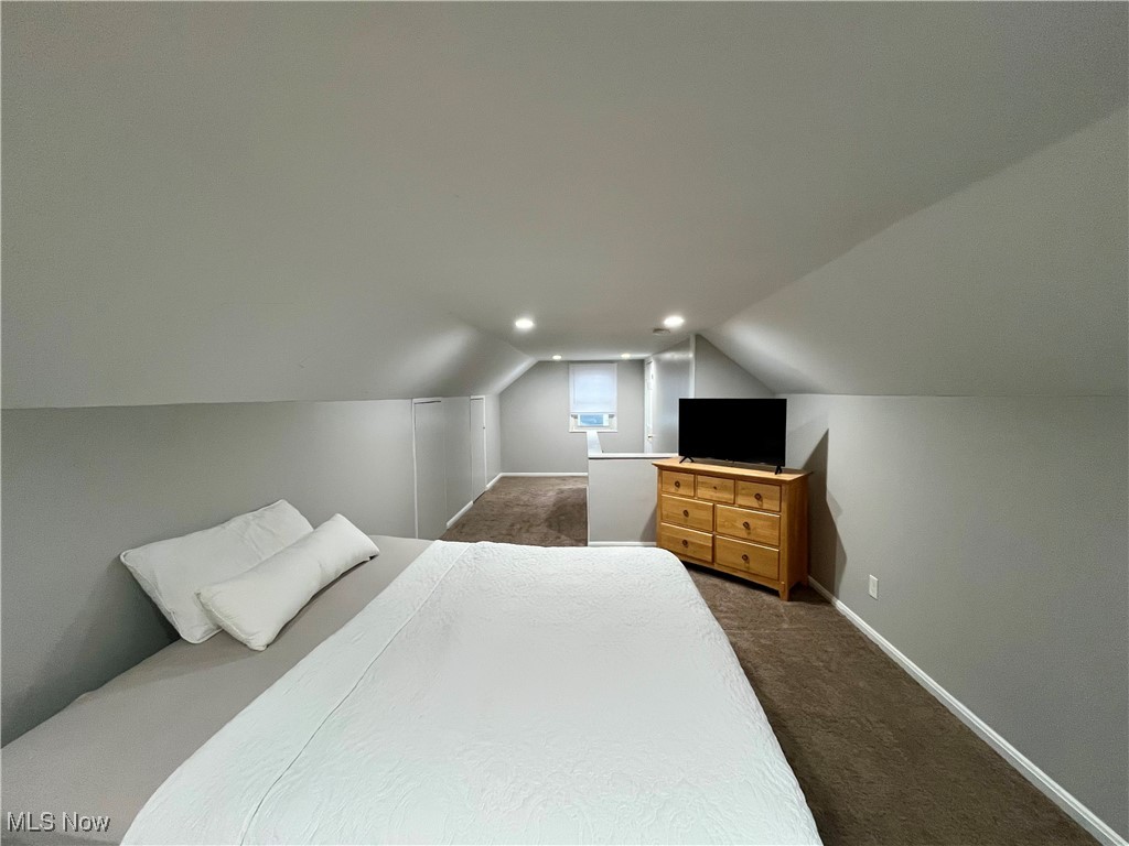 20907 Watson Road Maple Heights, OH 44137 - Photo 9 of 20 Bedroom with dark carpet and vaulted ceiling
