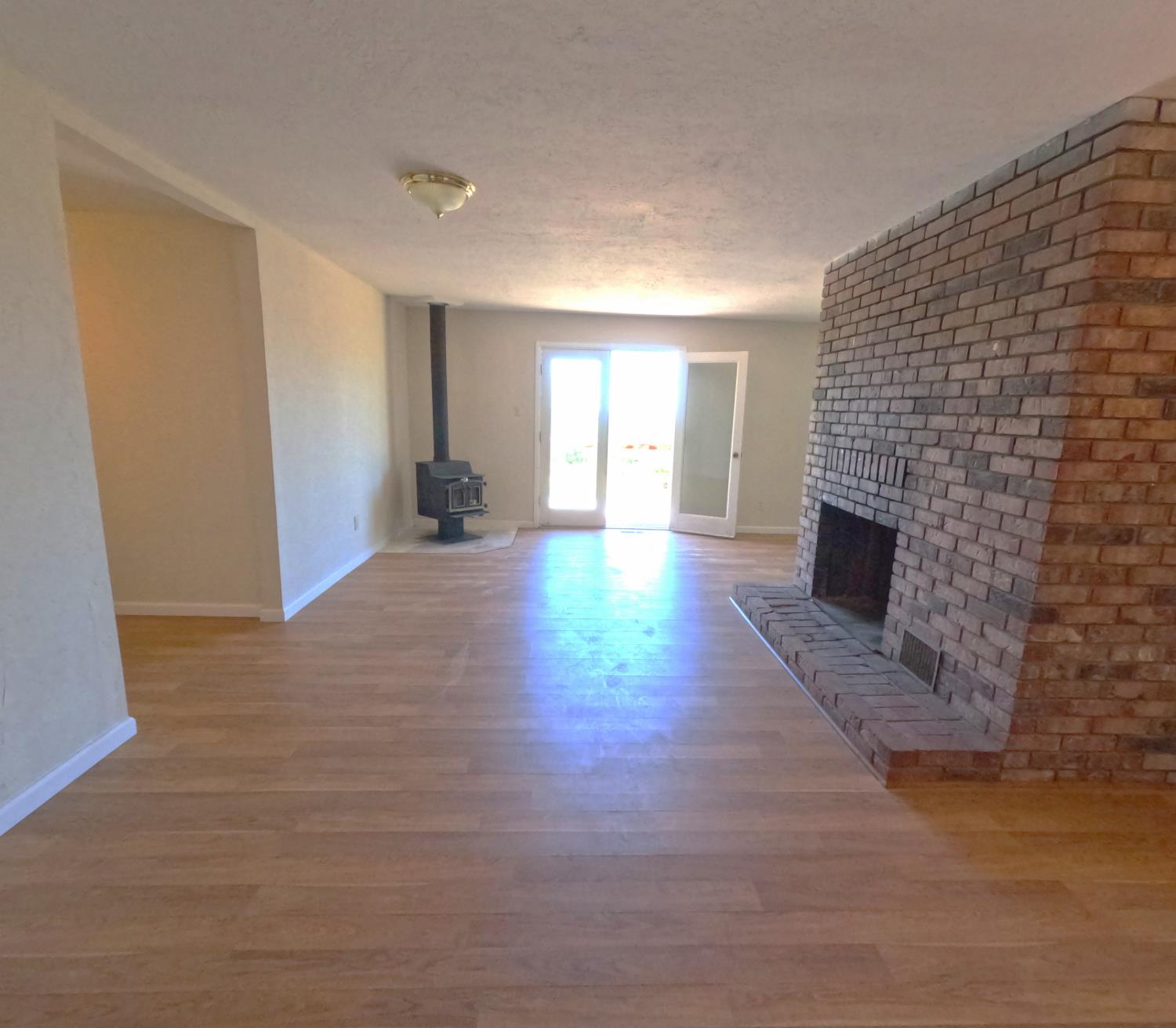 21665 Manton School Road Manton, CA 96059 - Photo 4 of 30 a view of a livingroom with wooden floor and a fireplace