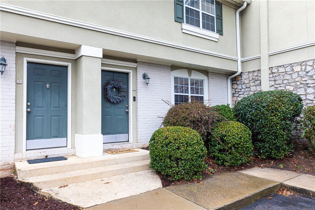 front view of a brick house with a small yard