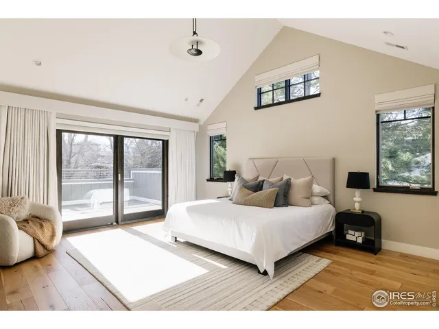 a bedroom with a large bed and a large window