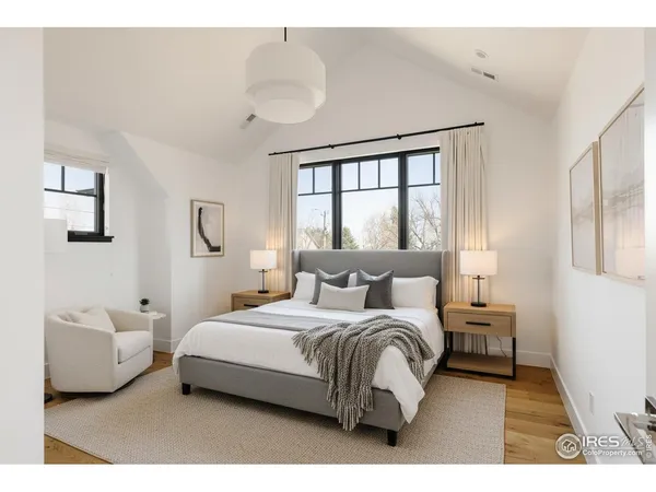 a bedroom with a large bed and a large window