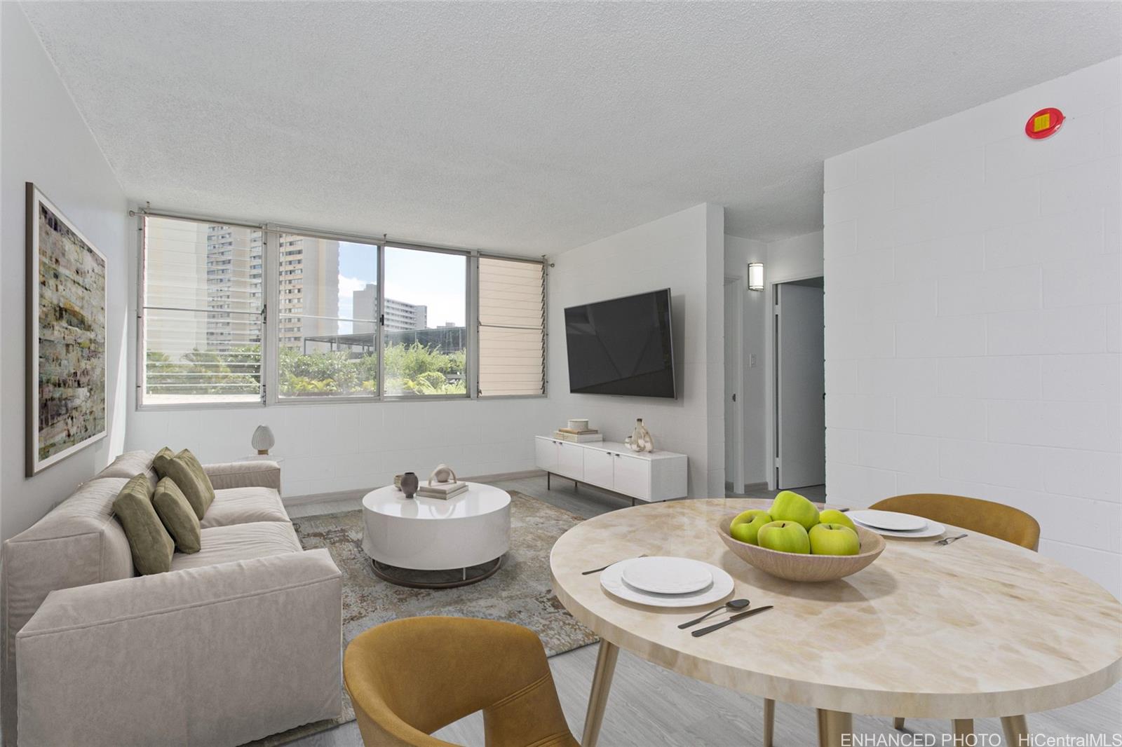 5122 Likini Street, Unit 214 Honolulu, HI 96818 - Photo 1 of 11 a living room with furniture and a flat screen tv